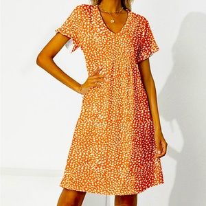 Ruffled v-necked flowing dress with gathered waist.